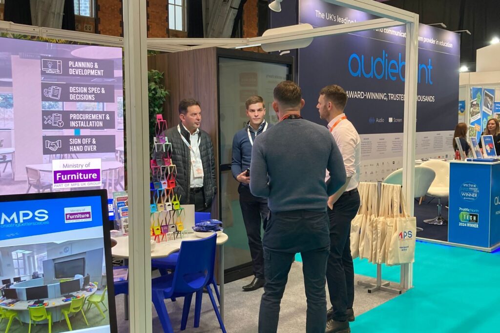 Staff interacting with visitors to the stand